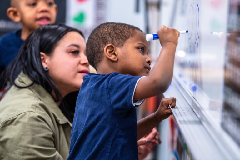 Student writing on a white board