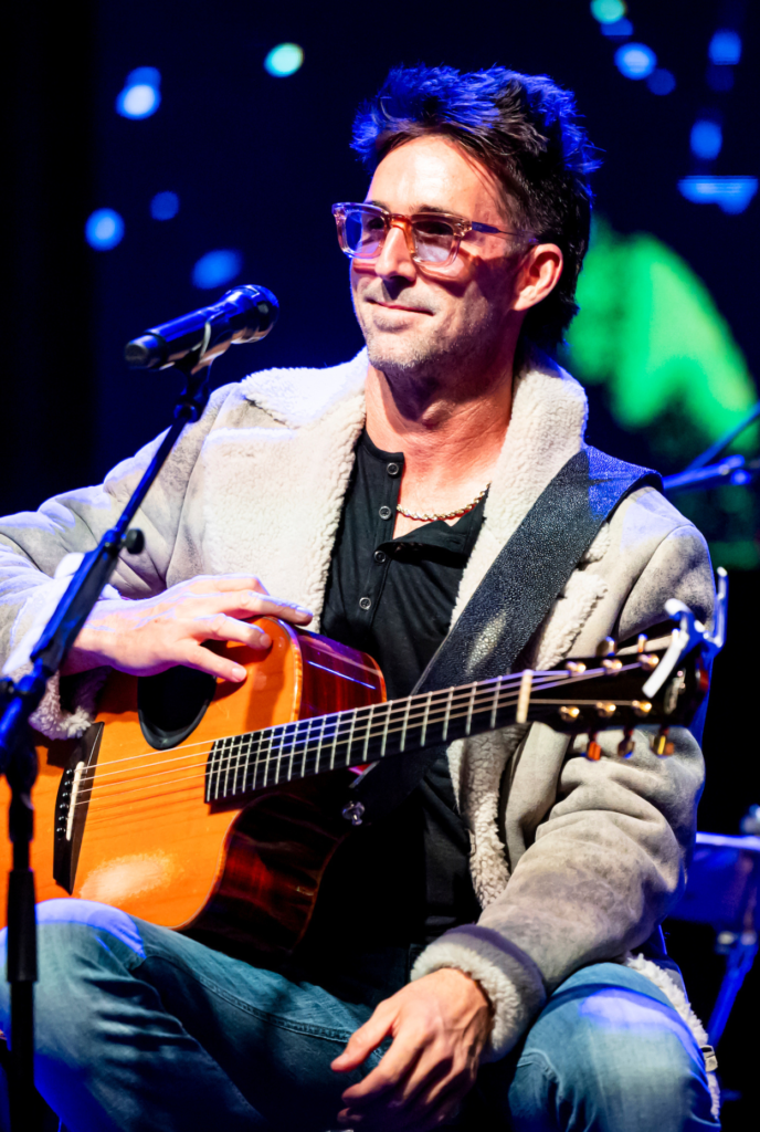 Jake Owen onstage with a guitar