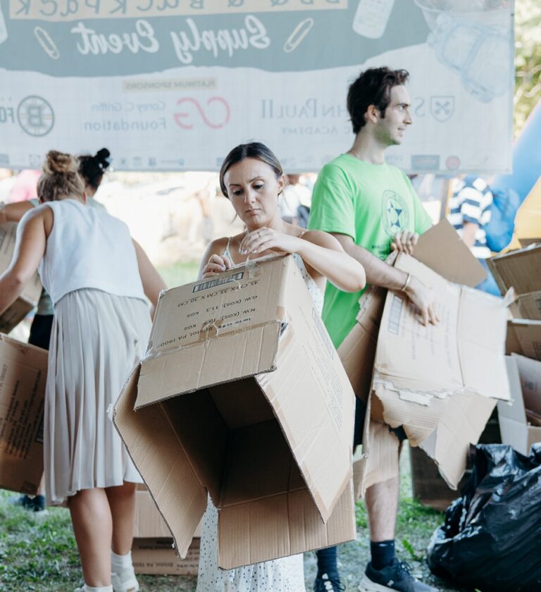 Backpack volunteers breaking down boxes