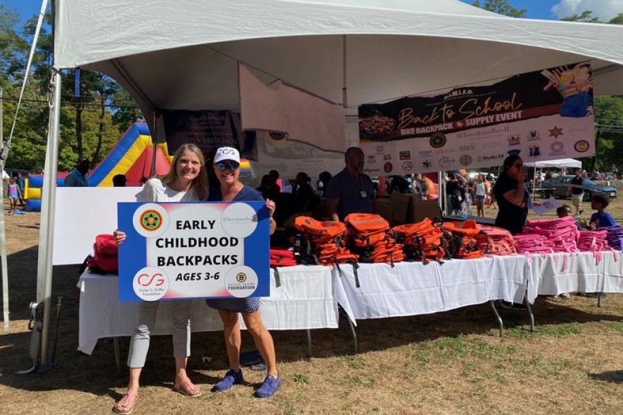 Volunteers giving away backpacks